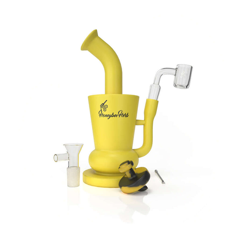 Yellow Honeybee Herb silicone travel bong rig with glass nail, glass flower bowl, and metal dab tool.